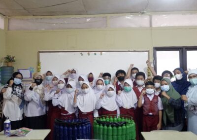 Students standing together with their teacher, Erlena, and Dr. Ishak