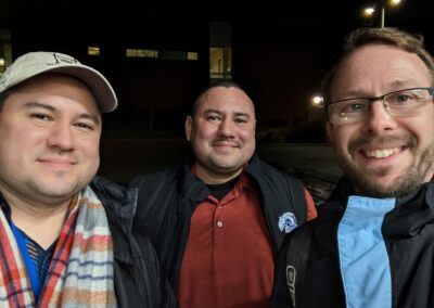 David, Daniel, and Lev in winter coats at night